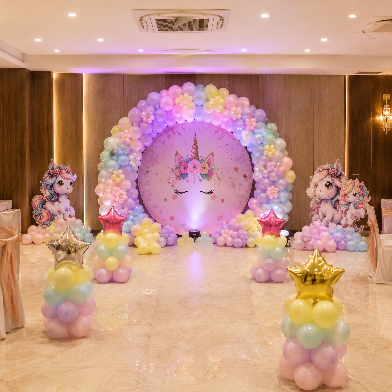 Pastel unicorn birthday balloon arch setup