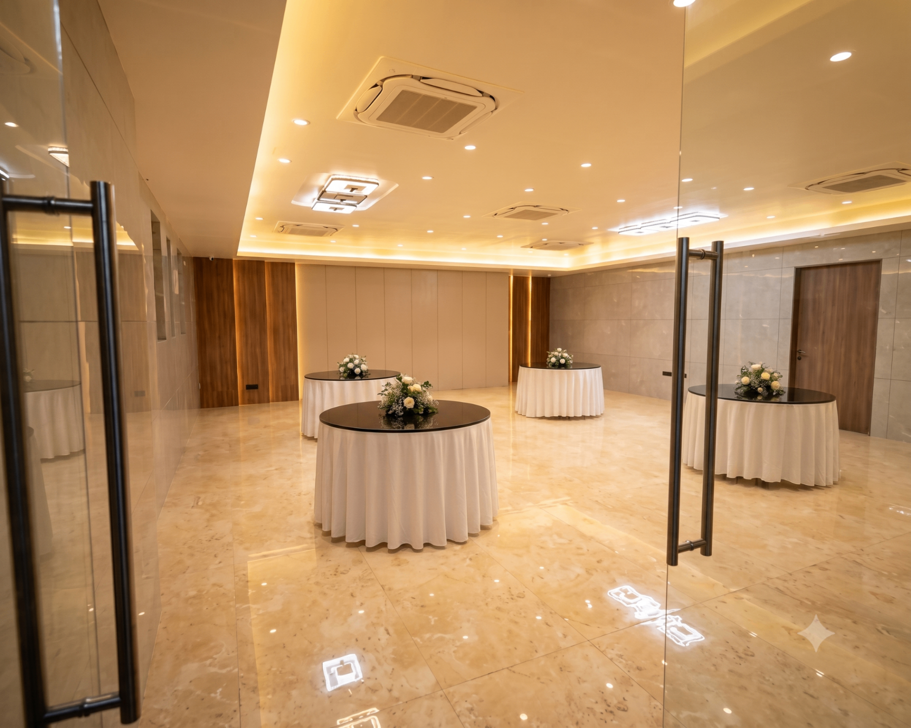 Welcome reception area with round cocktail tables and floral centerpieces